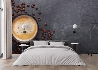 Horizontal banner with cup of coffee and coffee beans on dark stone background. Top view. Copy space Wall mural