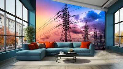 Silhouette of high-voltage electrical towers on a sunset background. Wall mural