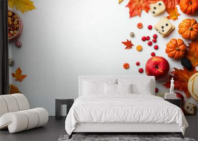 Autumn harvest display with vibrant leaves, fruits, and seasonal decor on a white backdrop Wall mural