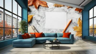 Autumn leaves and blank notepad on a textured surface with an orange pencil for creativity Wall mural