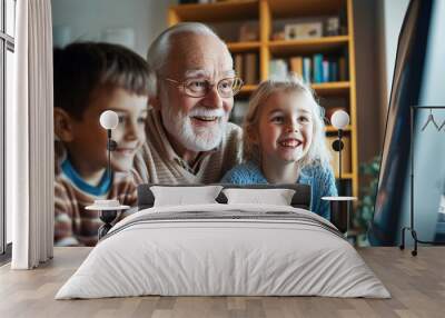 Grandfather enjoys computer fun with grandchildren at home on a sunny afternoon Wall mural