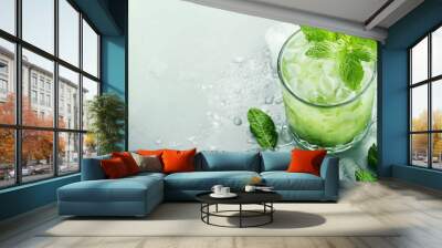 Refreshing mint cocktail with ice served on a chilled surface during summer afternoon Wall mural