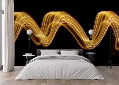 Gold light painting photography, long exposure photo of gold fairy lights in a swirling, wavy pattern against a black background Wall mural