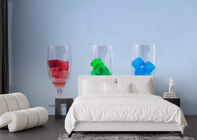 Creative concept of three wine glasses with rgb ice in them. Ice red, green and blue cocktails on grey background.. Wall mural