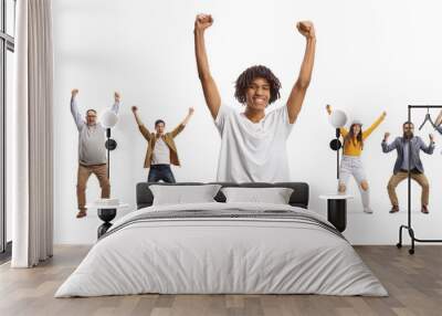 African american young man cheering and other people behind raising arms Wall mural