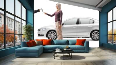 Auto mechanic returning keys to a female customer with a silver car Wall mural