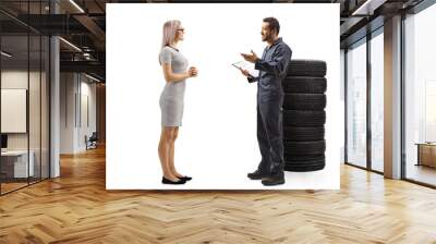 Auto mechanic talking to a young female customer Wall mural