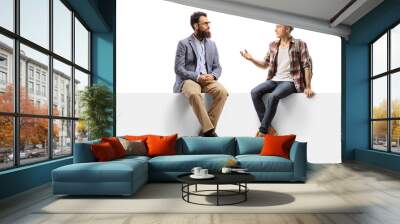 Bearded man and a teenage male student sitting on a panel and talking Wall mural