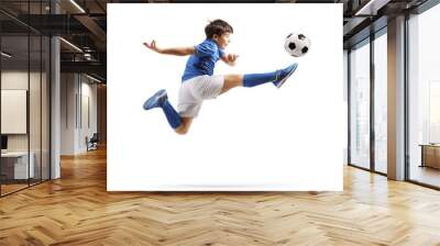 Boy in a sports jersey jumping and kicking a soccer ball Wall mural