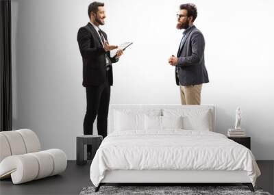 Businessman holding a clipboard and talking to a bearded man with glasses Wall mural