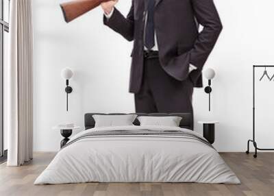 Businessman holding a rifle over his shoulder Wall mural