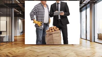 Businessman showing something on a tablet to a farmer Wall mural