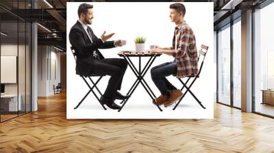 Businessman sitting in a cafe with a young male student Wall mural