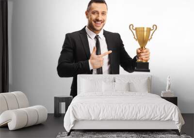 Businessman smiling and holding a golden trophy cup Wall mural