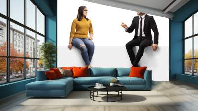 Businessman talking to a young female and sitting on a panel Wall mural