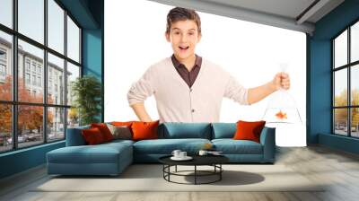 Cheerful boy holding a goldfish in a plastic bag Wall mural