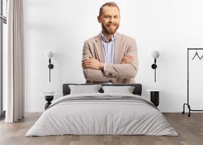 Cheerful professional man in a beige suit and jeans posing with crossed arms Wall mural