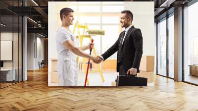 Decorator with a paint roller shaking hands with a businessman Wall mural