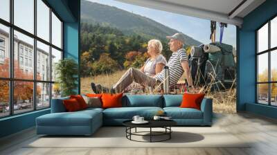 Elderly hikers sitting on a blanket Wall mural