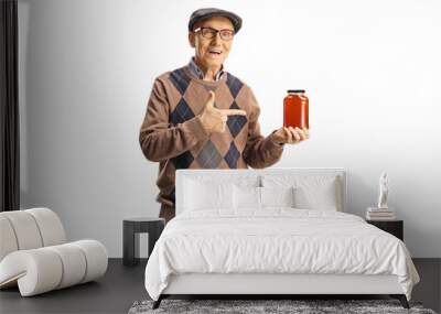 Elderly man holding a jar of honey and pointing Wall mural