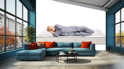 Elderly man in pajamas sleeping on a bed mattress Wall mural