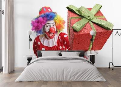 Excited funny clown holding a sparkly red gift box in front of the camera Wall mural