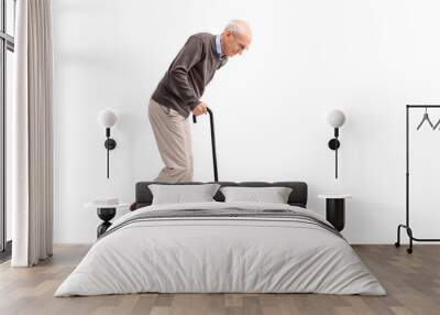 Exhausted old man walking with a cane Wall mural