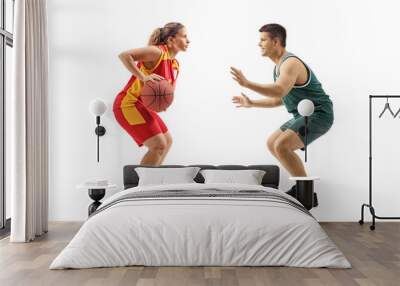 Female basketball player playing with a male basketball palyer Wall mural