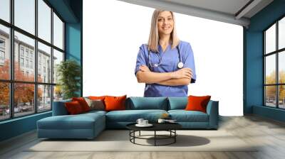 Female health care worker in a blue uniform smiling at camera Wall mural