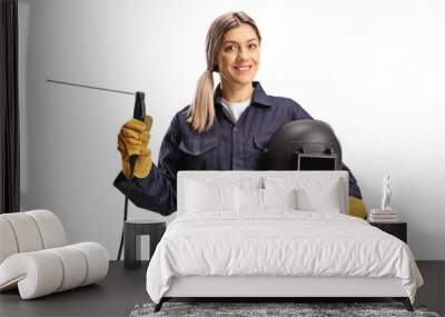 Female welder in a uniform with a welding machine and a helmet Wall mural