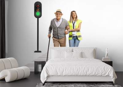 Full length portrait of a female community worker helping an elderly man crossing a street Wall mural