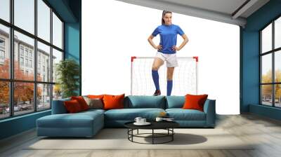 Full length portrait of a female football player posing in front of a mini goal Wall mural