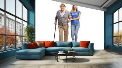 Full length portrait of a female volunteer helping an elderly man walking with a cane Wall mural