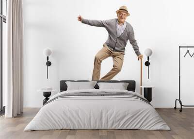 Full length portrait of a happy elderly man jumping Wall mural