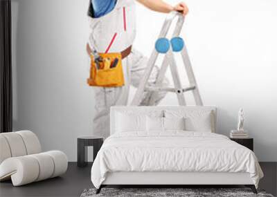 Full length portrait of a repairman on a ladder working with a h Wall mural