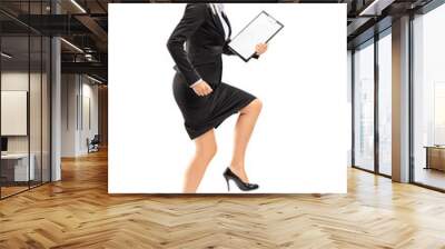 Full length portrait of a young businesswoman doing a huge step Wall mural