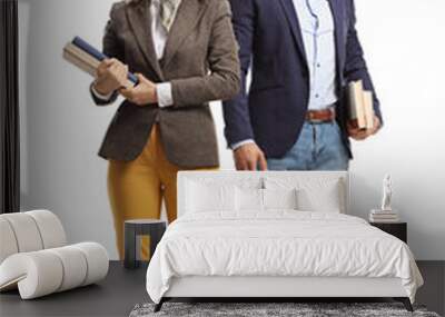 Full length portrait of a young man and woman standing and holding books Wall mural