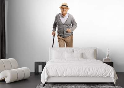 Full length portrait of an elderly man walking with a cane towards camera Wall mural