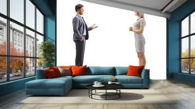 Full length profile shot of a man gesturing with hand and talking to a blond young woman Wall mural