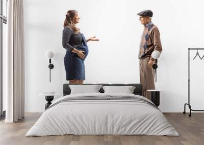 Full length profile shot of a pregnant woman talking to an elderly man Wall mural