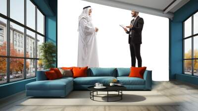 Full length profile shot of a young businessman talking to a mature arab man Wall mural