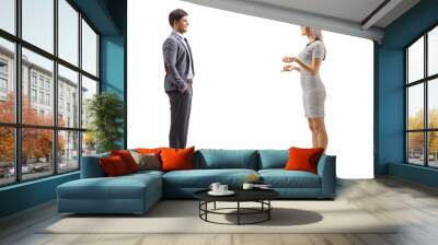 Full length profile shot of a young woman having a conversation with a man Wall mural