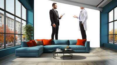 Full length profile shot of professional man in a suit talking to a male doctor Wall mural