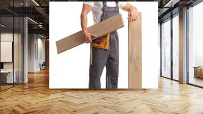 Full length shot of a carpenter holding wooden floor beams Wall mural