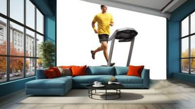 Full length shot of a smiling man in a yellow t-shirt running on a treadmill Wall mural