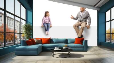 Grandfather talking to a little girl seated on a blank panel Wall mural