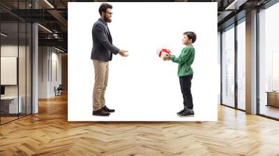 Little boy giving a gift box to his father Wall mural