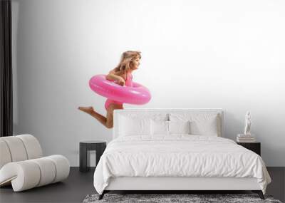 Little girl running with a pink rubber swimming ring Wall mural