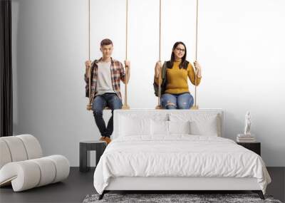 Male and female teenage students sitting on a swing Wall mural