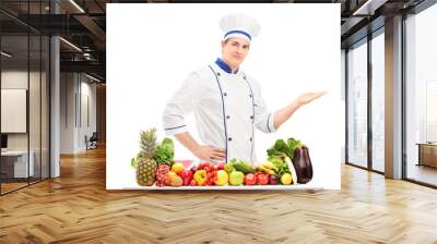 Male chef in a uniform gesturing with hand and posing behind a t Wall mural